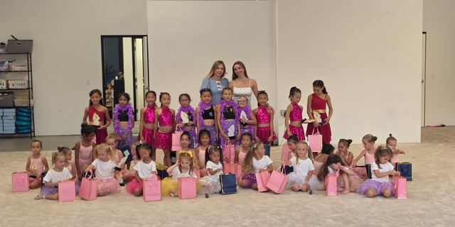The whole club gathered on the floor with their coaches after the 2026 Summer Show